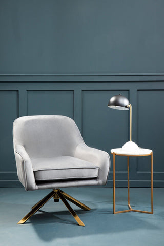 Avery grey velvet swivel chair featuring a sleek light grey velvet swivel design with a gold-tone star-shaped base