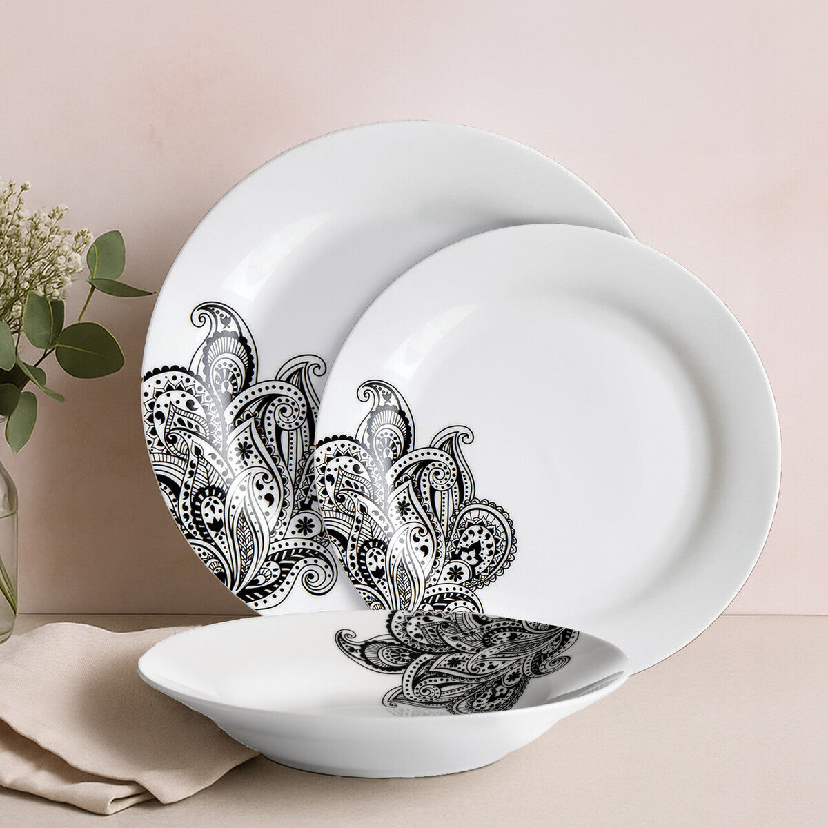 White ceramic avie prince 12 piece black dinner set with intricate black paisley rim patterns on plates and bowl