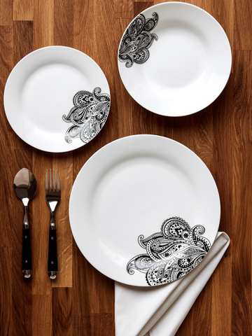 White ceramic plates with black paisley designs on rim from avie prince 12 piece black dinner set