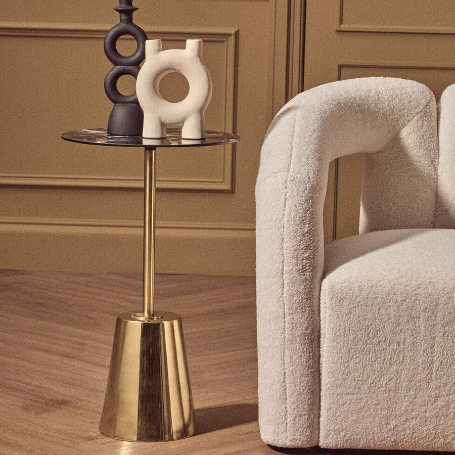 Gold base side table with black marble effect top and reflective glass surface with a flared base design