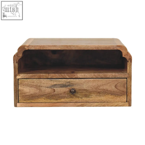 A rustic avora wall mounted bedside table in natural mango wood with a drawer, open shelf, and dark metal knob