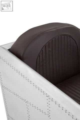 Avro armchair with dark brown faux leather upholstery and white metal frame featuring rivet detailing