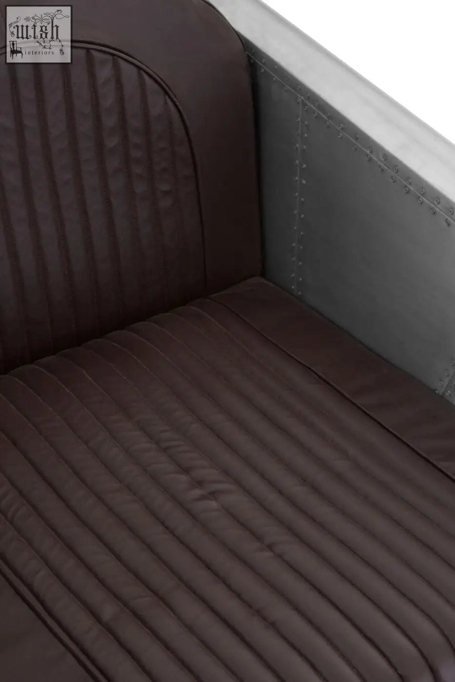 Avro armchair with dark brown faux leather ribbed upholstery and riveted metal frame inspired by airplane seats