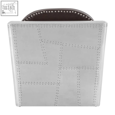 Silver airplane-inspired avro armchair with dark brown faux leather seat and rivet details along the edges