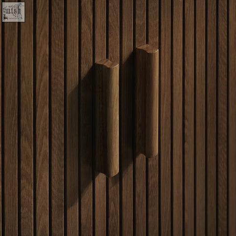 Two sleek wooden cabinet handles with warm brown finish and natural grain on axel 2 door fluted dining sideboard