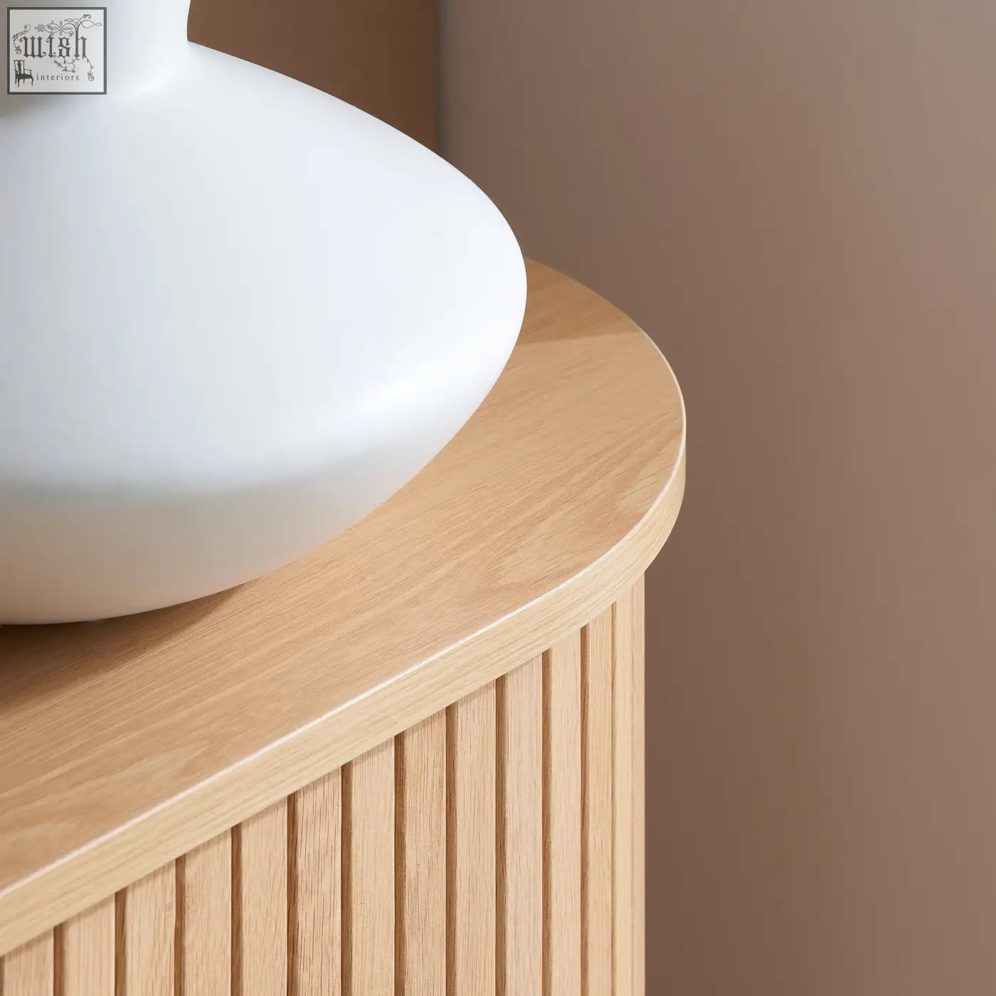 White ceramic vase on light wood side table with vertical slats beside axel 2 door fluted sideboard in fluted dining range