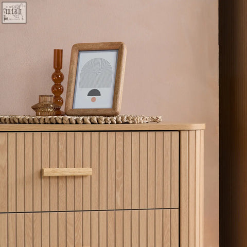 Light wood framed picture with minimalist abstract design complements axel 6 drawer chest from fluted bedroom range
