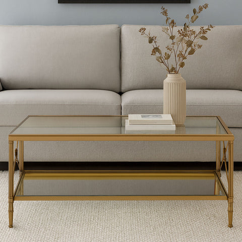Axis coffee table with gold finish frame featuring a glass top, lower shelf, and bamboo style legs gold coffee table