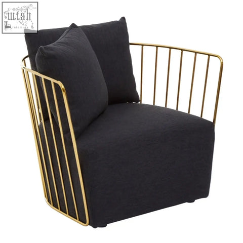 Black upholstered armchair with a gold-toned metal frame featuring vertical bars black metal chair design