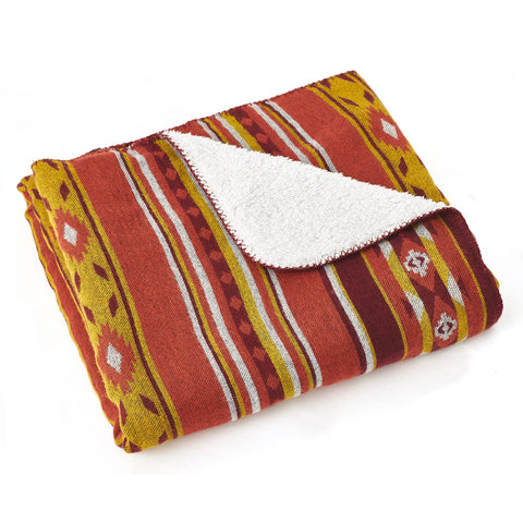 A cozy aztec pattern throw blanket in red and orange with soft sherpa lining perfect for camping and outdoor use
