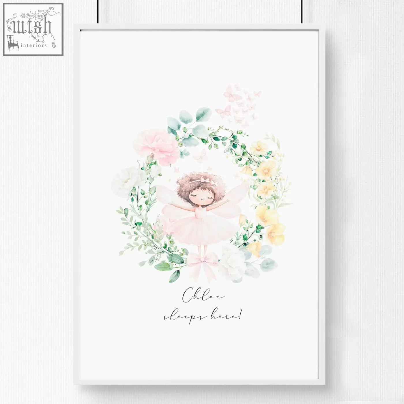 A delicate watercolor wall art print of a sleeping ballerina with pink flowers in a white frame for baby’s room