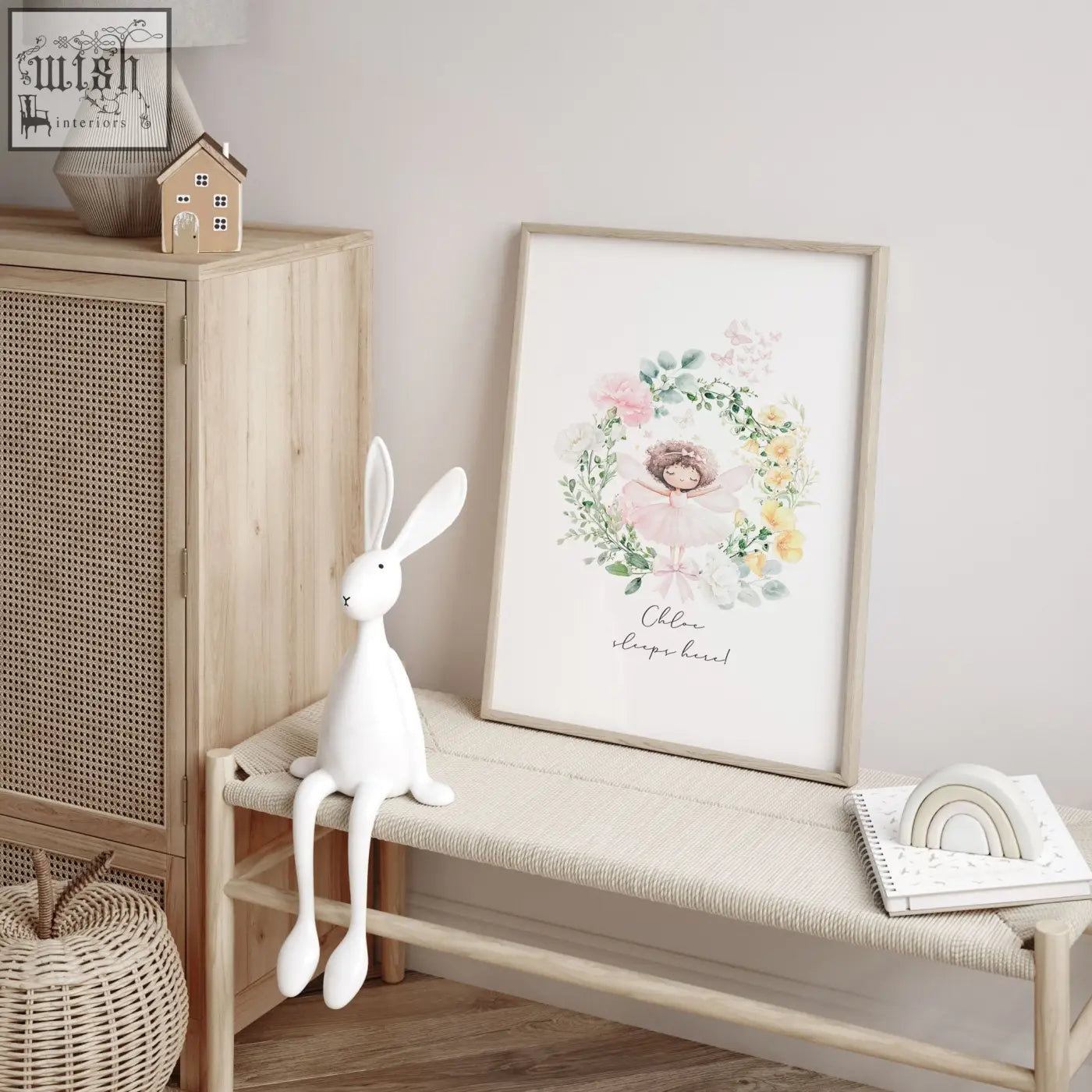 A framed watercolor wall art print of a ballerina with pastel flowers and chloé sleeps here text for baby’s room