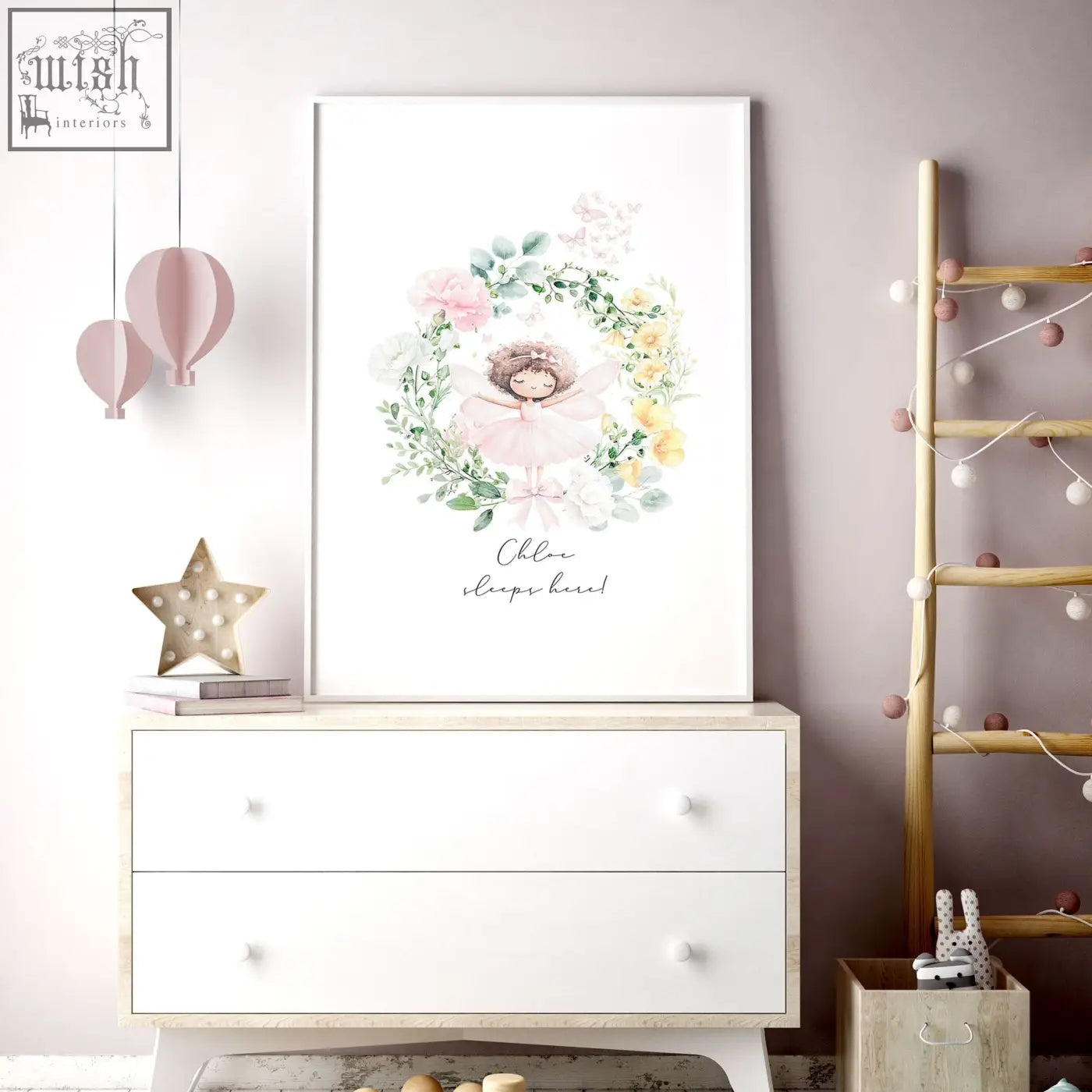 A framed watercolor wall art print of a fairy with pink and yellow flowers and personalized text for baby’s room