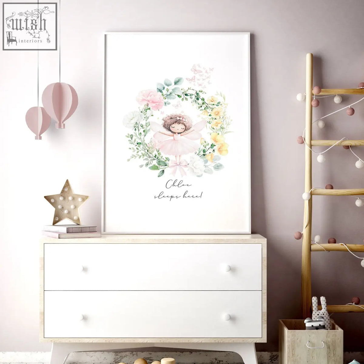 A framed watercolor wall art print of a fairy with pink and yellow flowers and personalized text for baby’s room