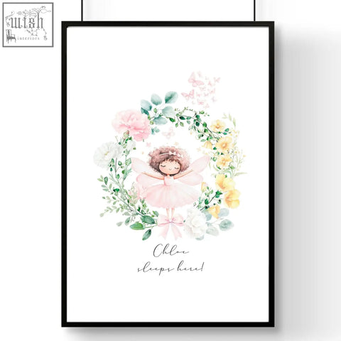 A framed watercolor wall art print of a pink ballet dancer with floral wreaths and chloe sleeps here text for a baby’s room