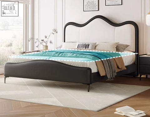 Black leather badham king size bed with curved headboard and footboard featuring white tufted center panel