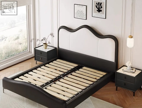 Black and white leather badham king size bed with curved upholstered headboard for a stylish bedroom setup