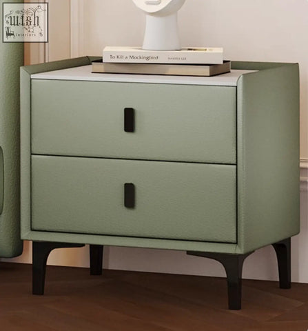 Modern sage green faux leather nightstand with sleek black handles and tapered legs for badham king size bed setup