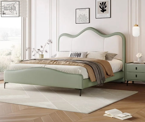 A sage green badham king size bed with leather upholstery and white tufted curved headboard and footboard