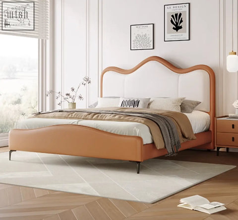 A sleek modern badham king size bed with a curved orange leather headboard and matching leather base