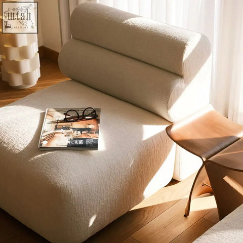 Beige velvet upholstered seater corner sofa with segmented rounded backrest and cushioned seat for comfy lounging