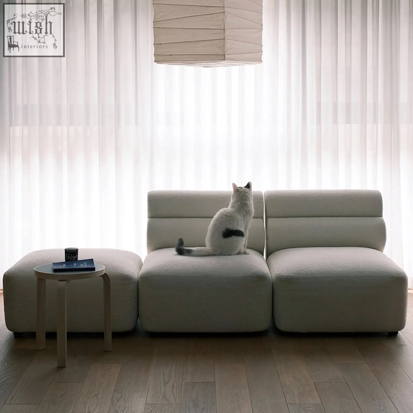 A sleek off-white velvet three seater corner sofa with modular design and segmented cushions for modern spaces
