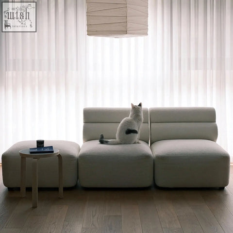 A sleek off-white velvet three seater corner sofa with modular design and segmented cushions for modern spaces
