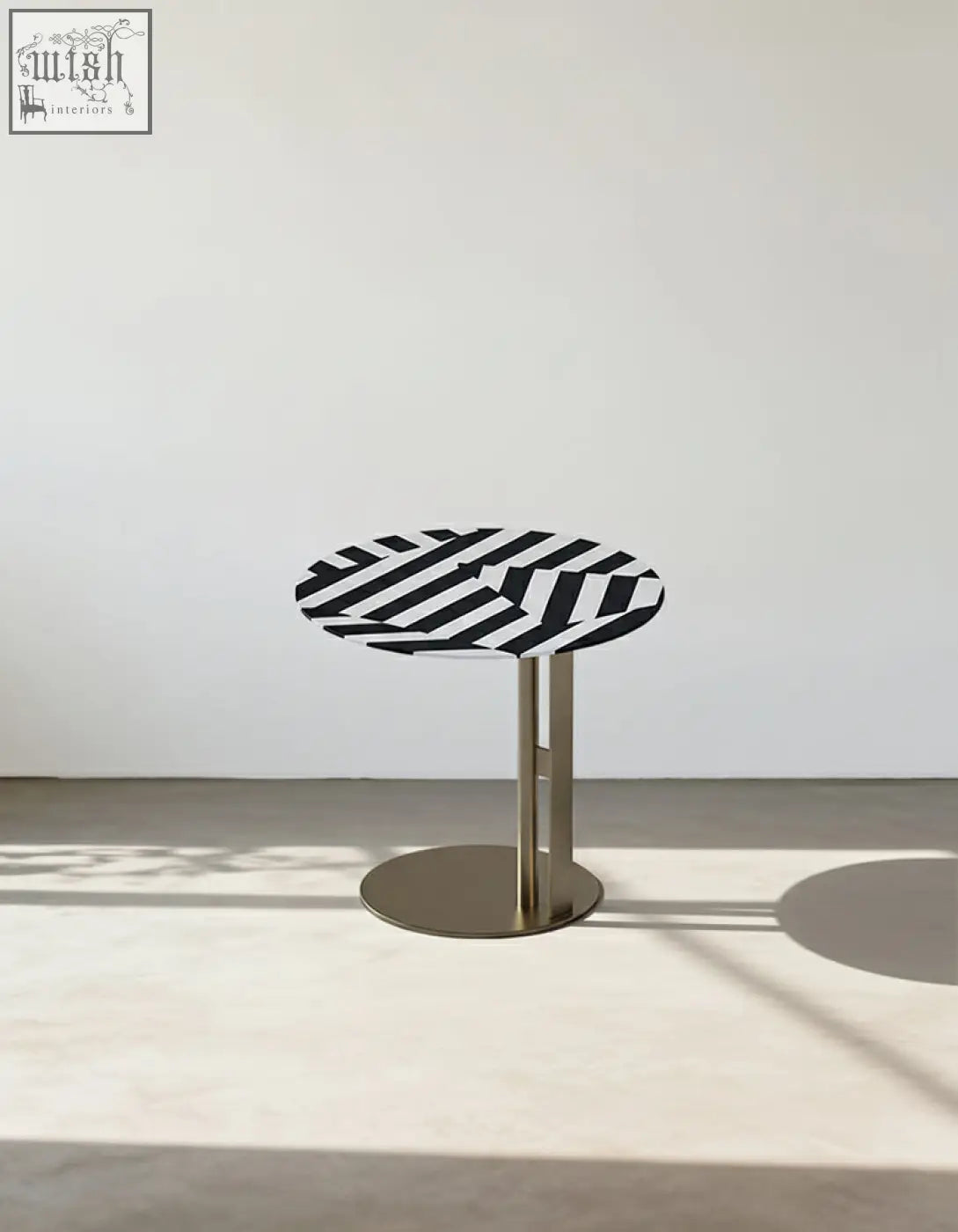 Bagley coffee table with a sleek round black and white striped top and stainless steel pedestal base perfect for coffee tables