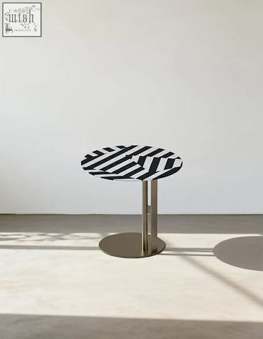 Bagley coffee table with a sleek round black and white striped top and stainless steel pedestal base perfect for coffee tables