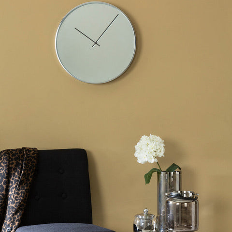 Bailie chrome and mirror wall clock with sleek silver frame and minimalist design on a light gray face wall clock