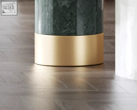 A sleek bain coffee table set with a dark green marble top and polished gold cylindrical side table base