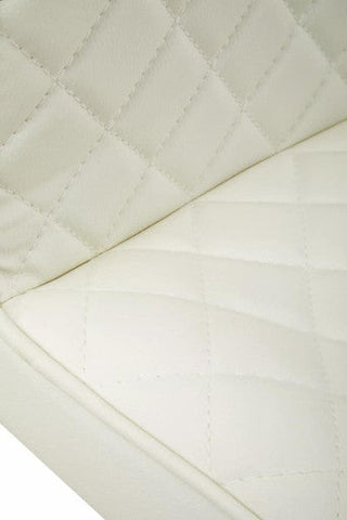 Cream-colored quilted leather cushion with diamond stitch on baina white leather effect black base bar chair