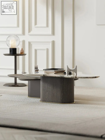 Modern oval baines marble coffee table with sleek dark gray wood grain base and polished marble top for stylish living rooms
