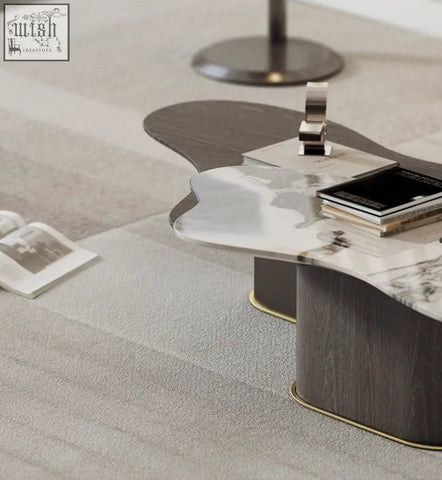 Modern baines marble coffee table with polished marble top dark wood base and gold trim in a sleek organic shape