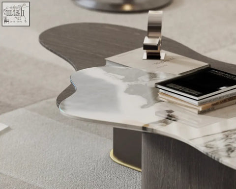 Modern baines marble coffee table with sleek silver and dark wood top supported by sturdy matte black legs