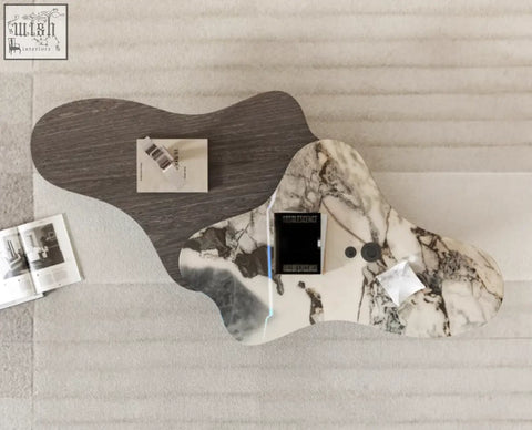 Organic-shaped baines marble coffee table with dark wood base and white marble patterned surface for stylish living rooms