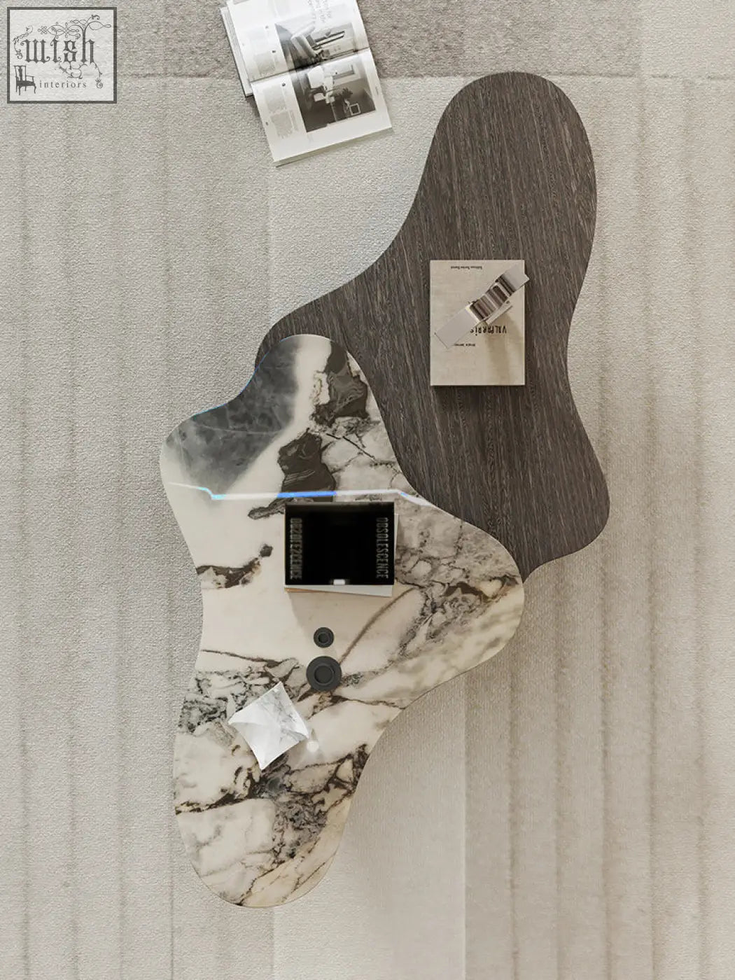 Organic-shaped baines marble coffee table with two-tone marble top and black circular controls in a sleek design