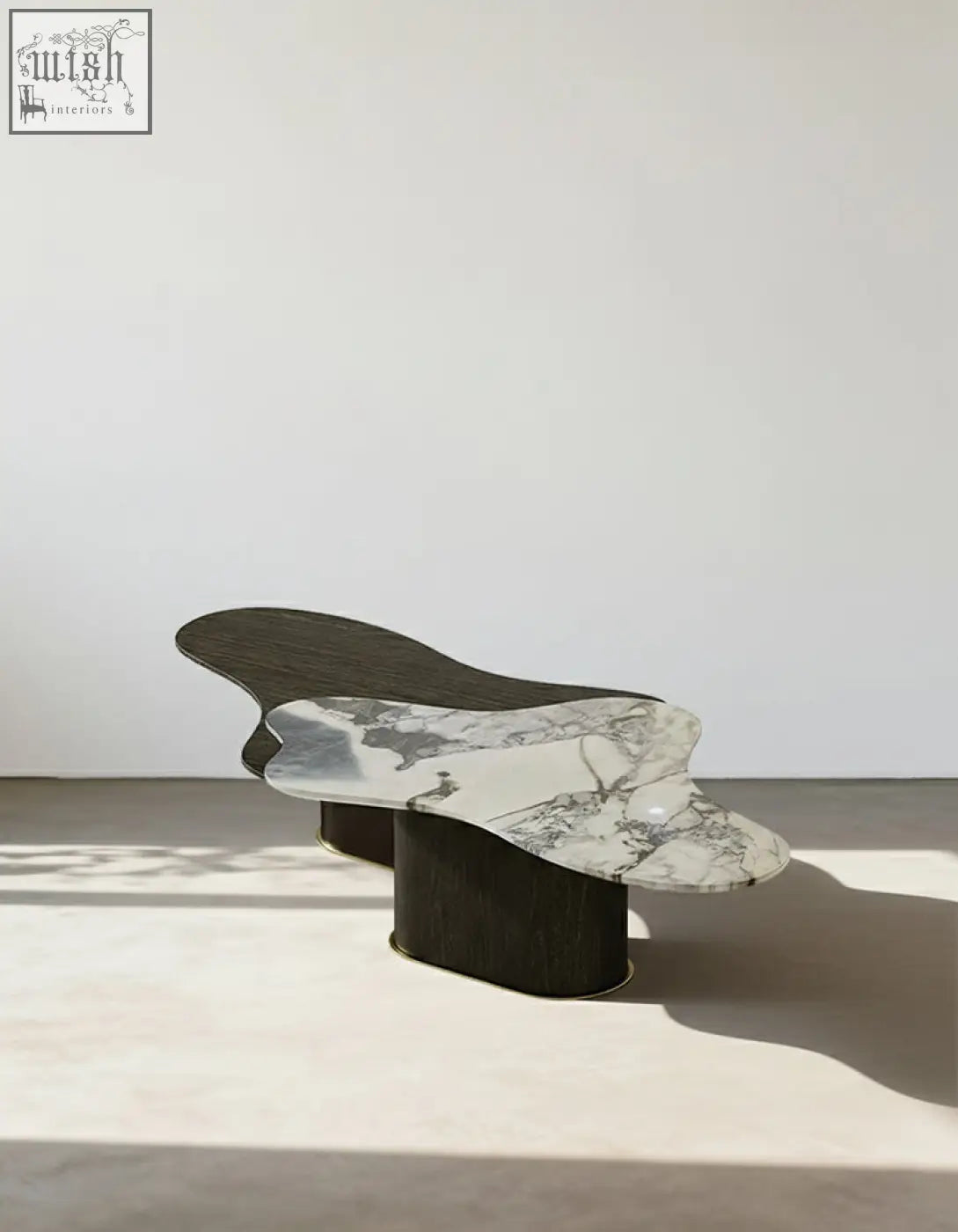 Organic-shaped baines marble coffee table with white marble top and dark wood legs perfect for stylish living rooms