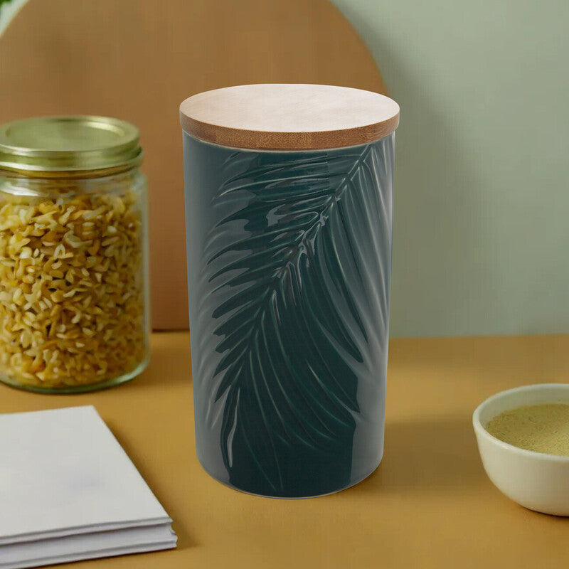 Bali dark green ceramic storage jar with embossed palm leaf design and bamboo lid for stylish kitchen storage