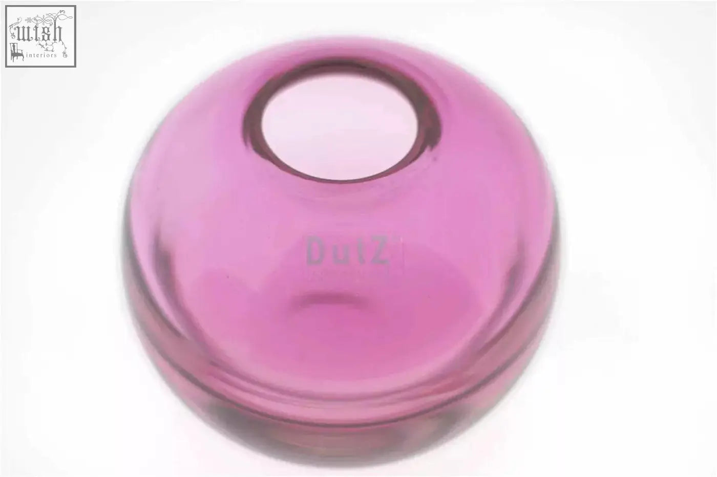 A translucent pink mouth blown glass ball vase with circular opening from the dutz collection fuchsia color