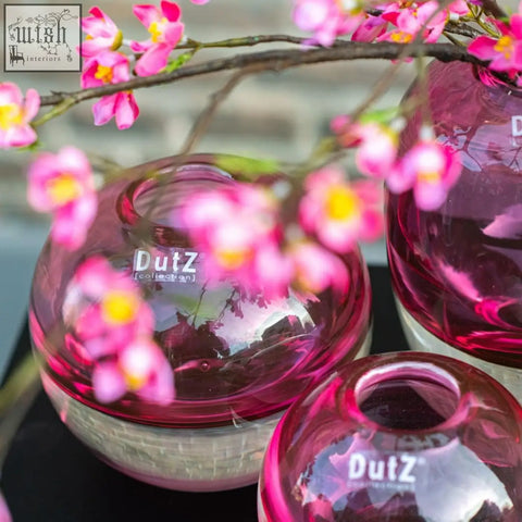 Vibrant pink mouth blown glass ball vase with glossy finish and textured base from dutz collection fuchsia color