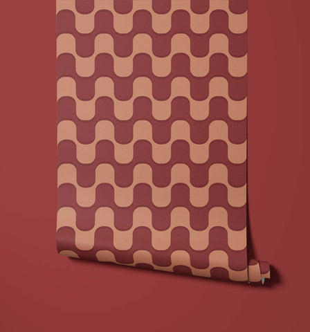 A roll of ballinger wallpaper with a repeating wavy pattern in muted terracotta and dusty rose tones