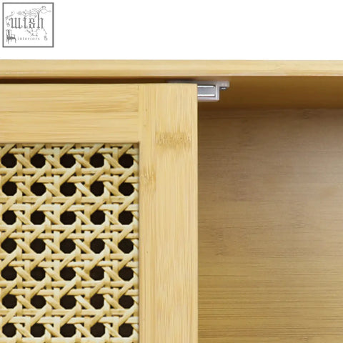 Light-colored solid wood wall cabinet with woven cane panel and metal hinge for kitchen storage or bathroom use