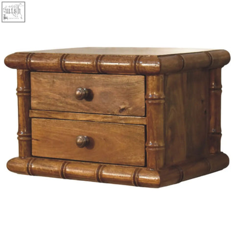 A rustic wooden bamboo-style two-drawer jewelry box with amber oak finish and round metal knobs