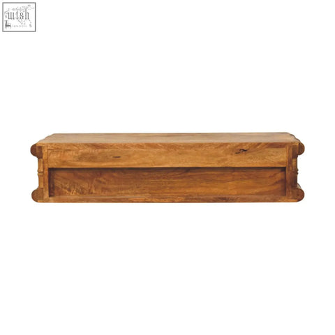 A rustic wooden coffee table with warm natural finish and carved corners shown with bamboo wall-mounted console