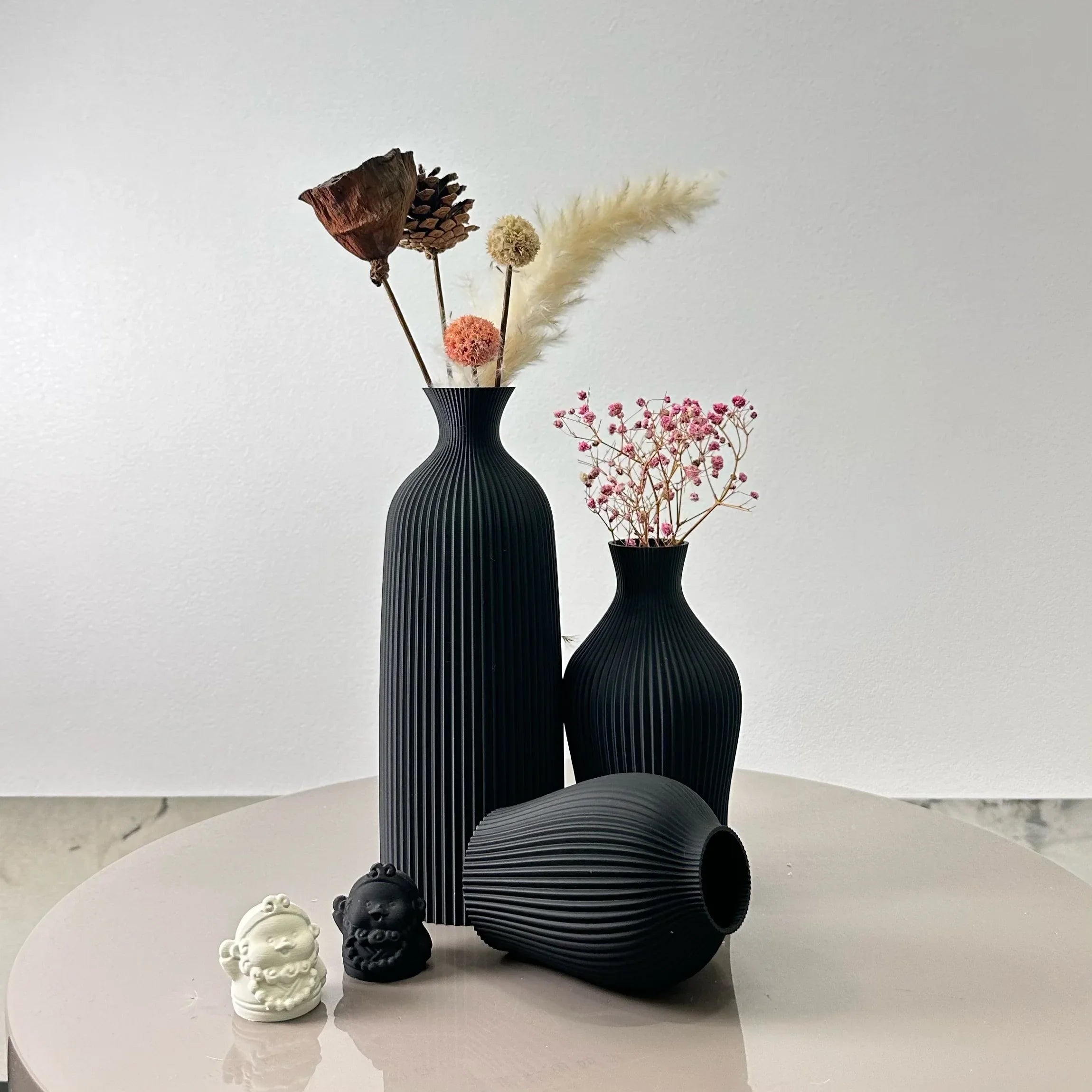 Black ribbed ceramic bara vases with dried floral arrangements perfect for stylish home decor