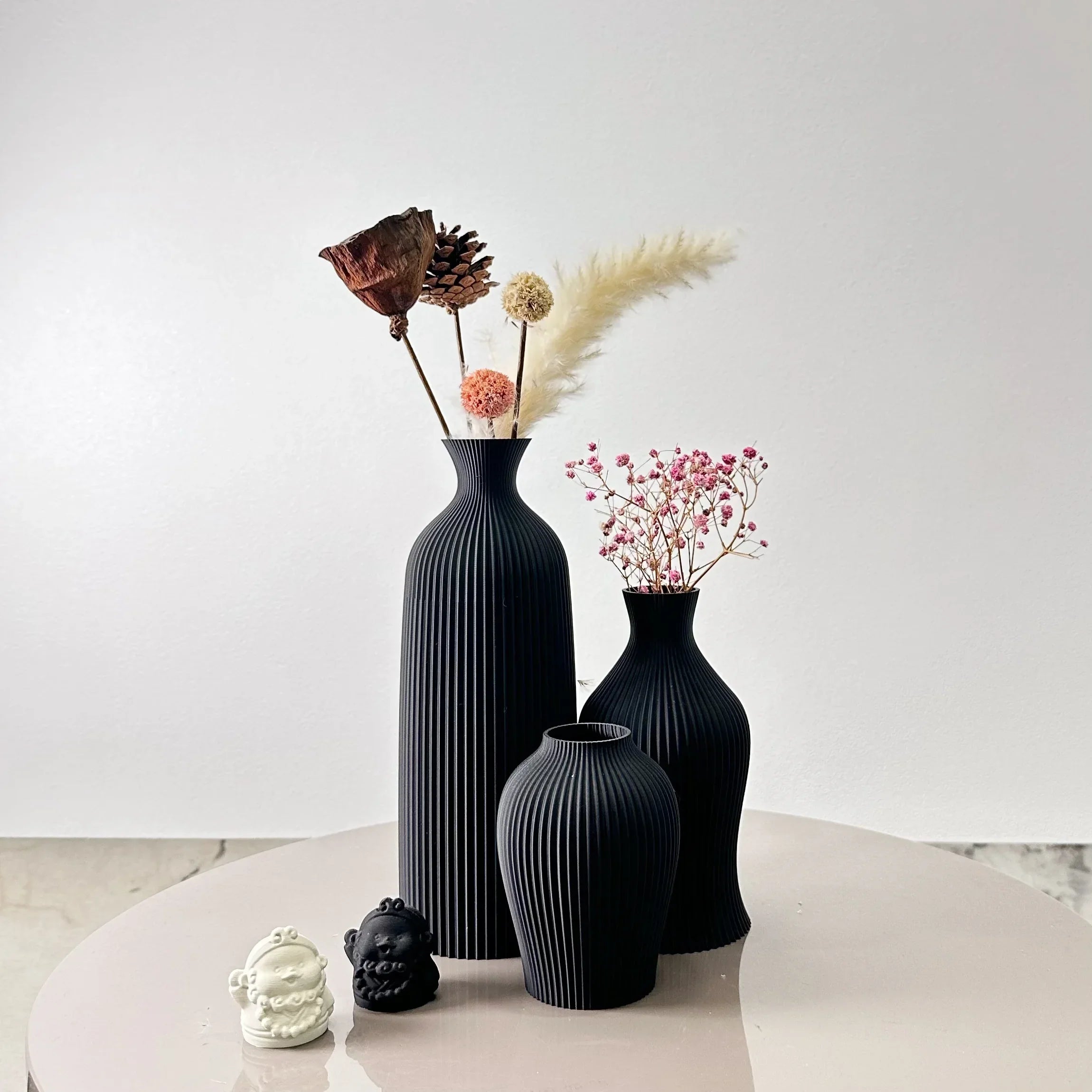 Black ribbed ceramic bara vases with dried floral arrangements perfect for stylish home decor