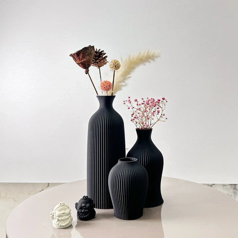 Black ribbed ceramic bara vases with dried floral arrangements perfect for stylish home decor