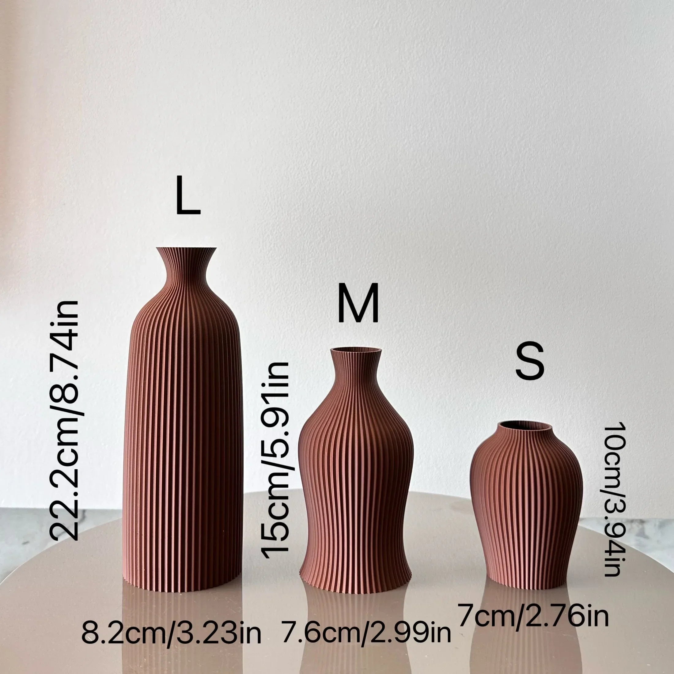 Set of three terracotta ceramic bara vases with vertical ribbed texture labeled l m and s