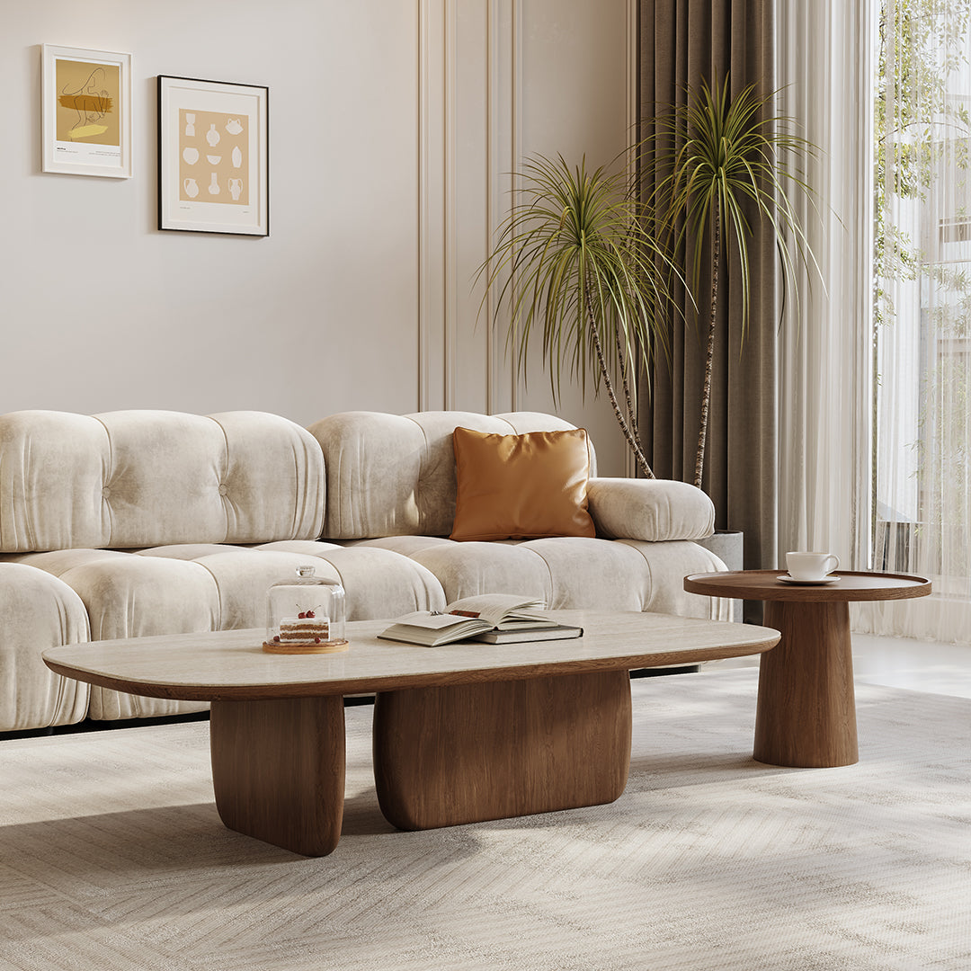 Modern oval barakat travertine coffee table set with light wood top and dark brown sculpted base in walnut finish